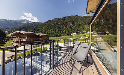 Balkon des Zimmers Heimatblick im Genusshotel Vermala mit Sitzgelegenheit und Blick auf die Montafoner Bergwelt.